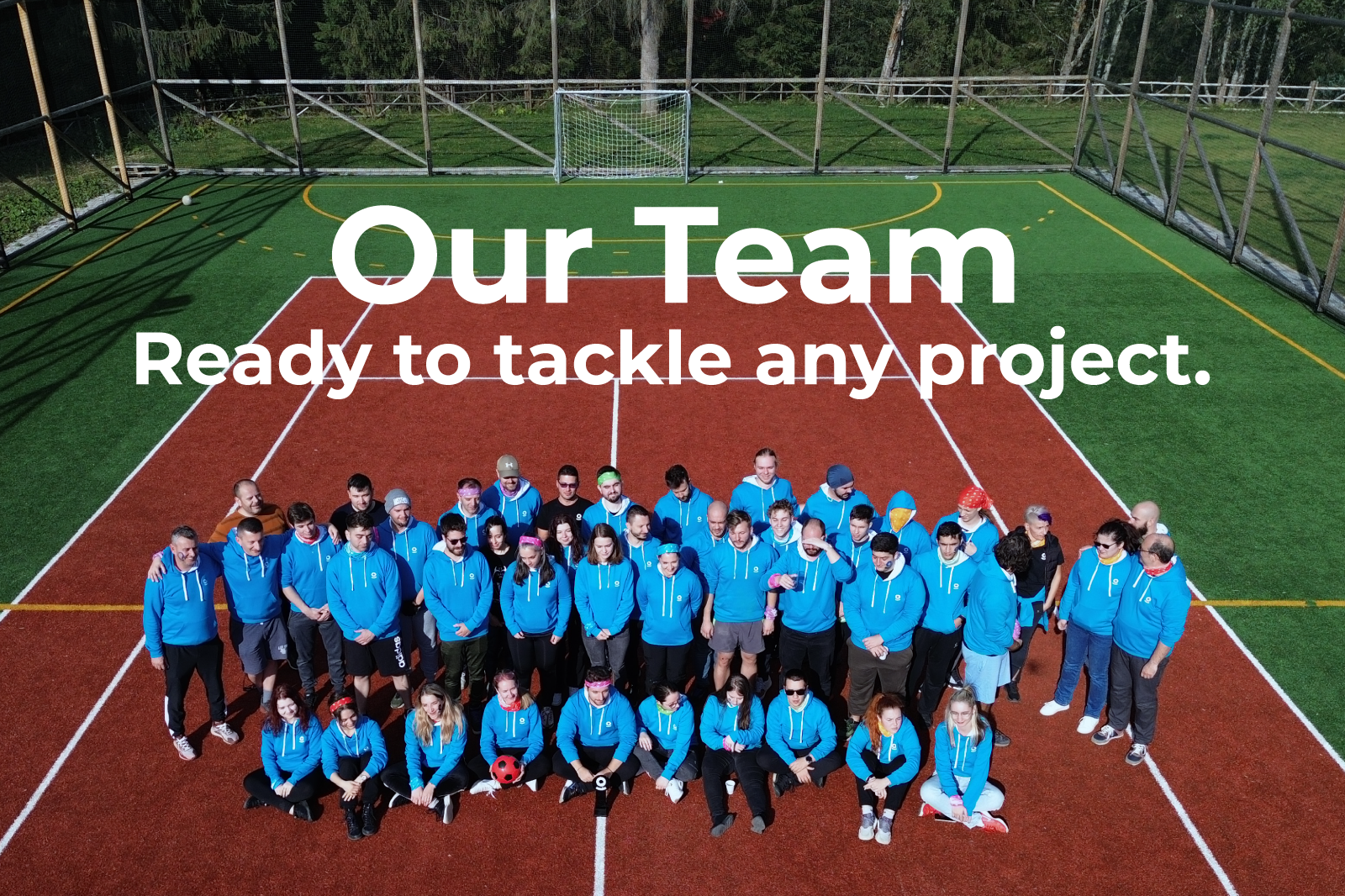 Team Ontegra posed together on a sports field, symbolizing teamwork and readiness to tackle complex projects.